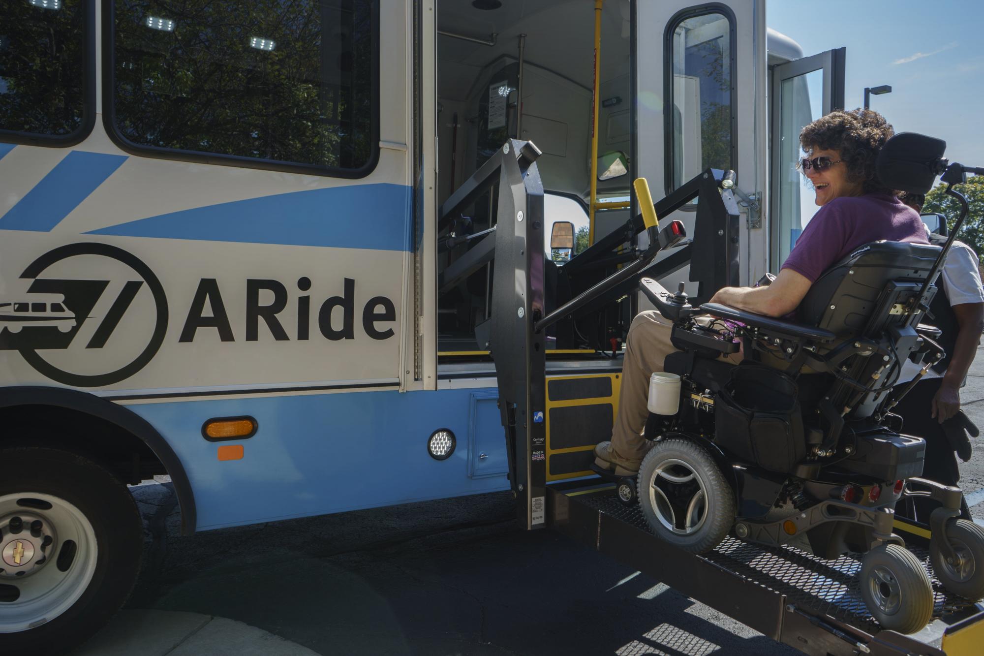 Someone in a wheelchair making their way onto a bus