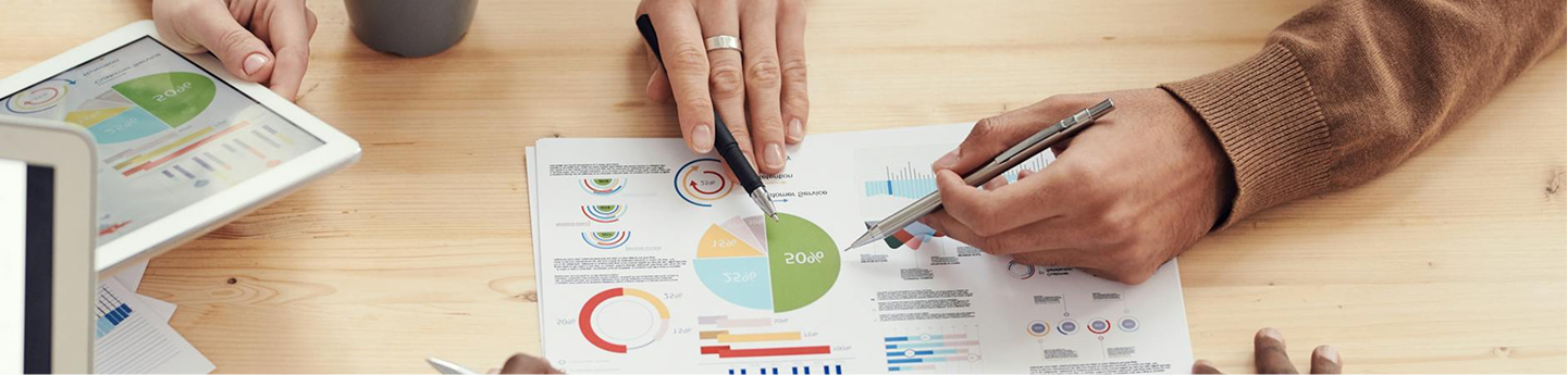 people planning pointing at paperwork with charts