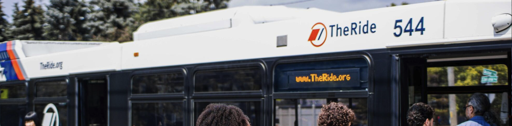 people getting on a bus