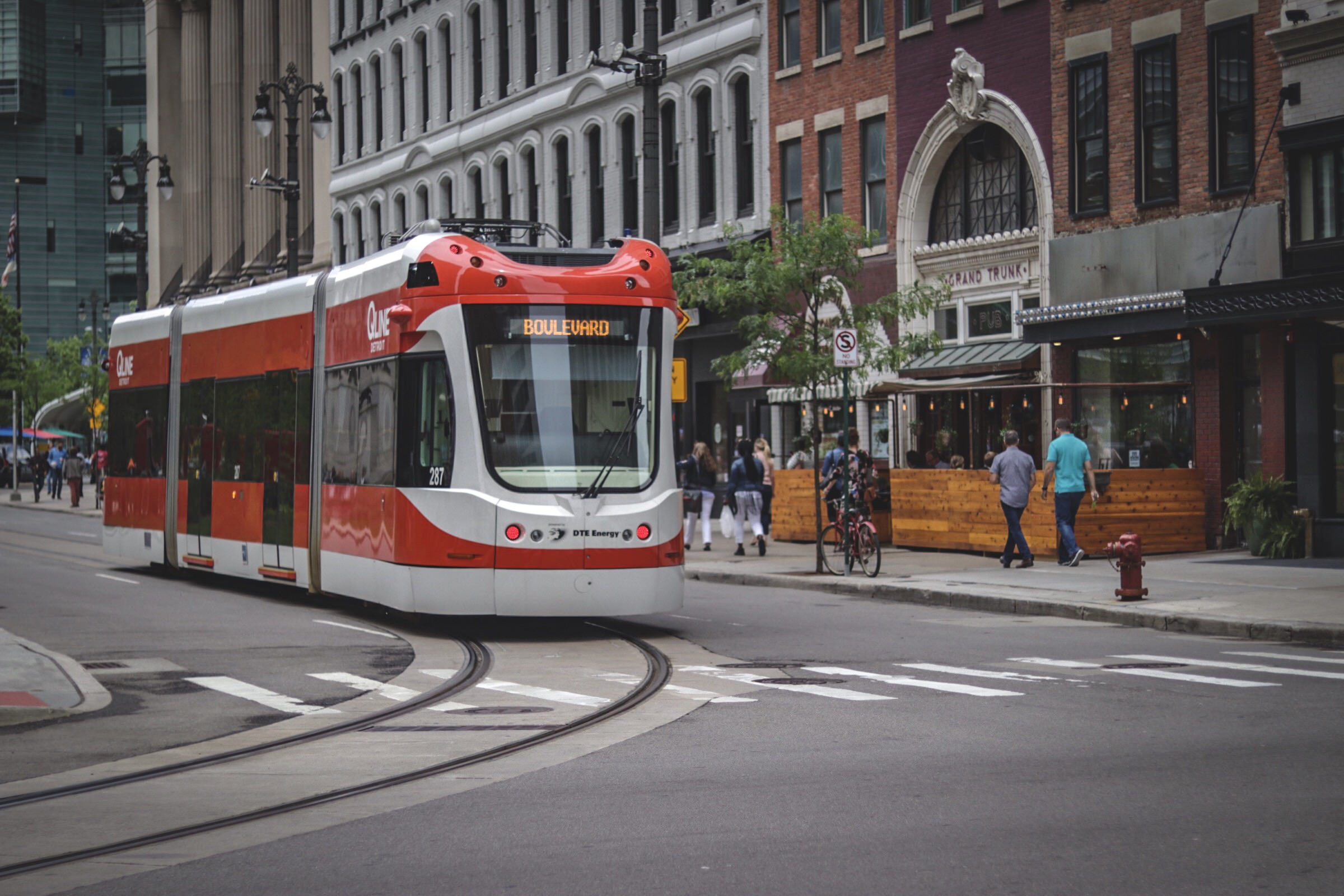A QLINE bus traveling down the boulevard