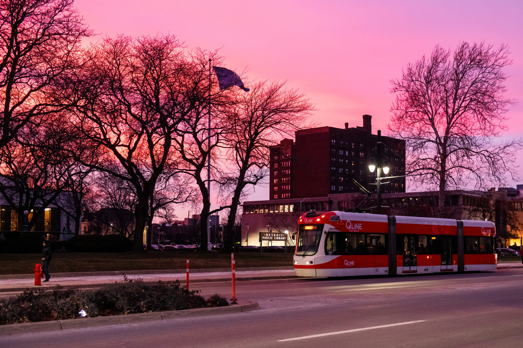 The QLINE riding down the road while the sun goes down
