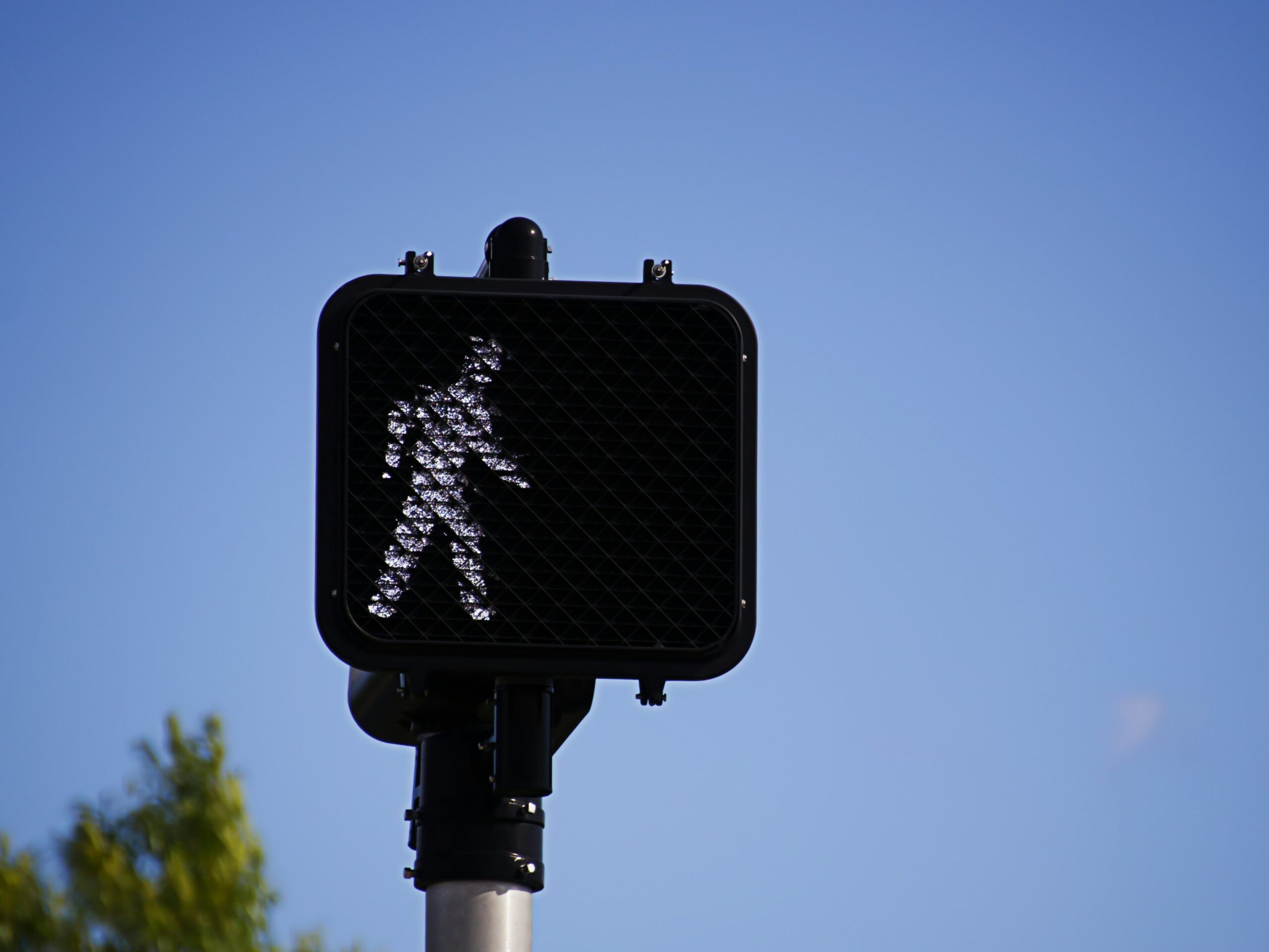 A crosswalk sign indicating that people may walk
